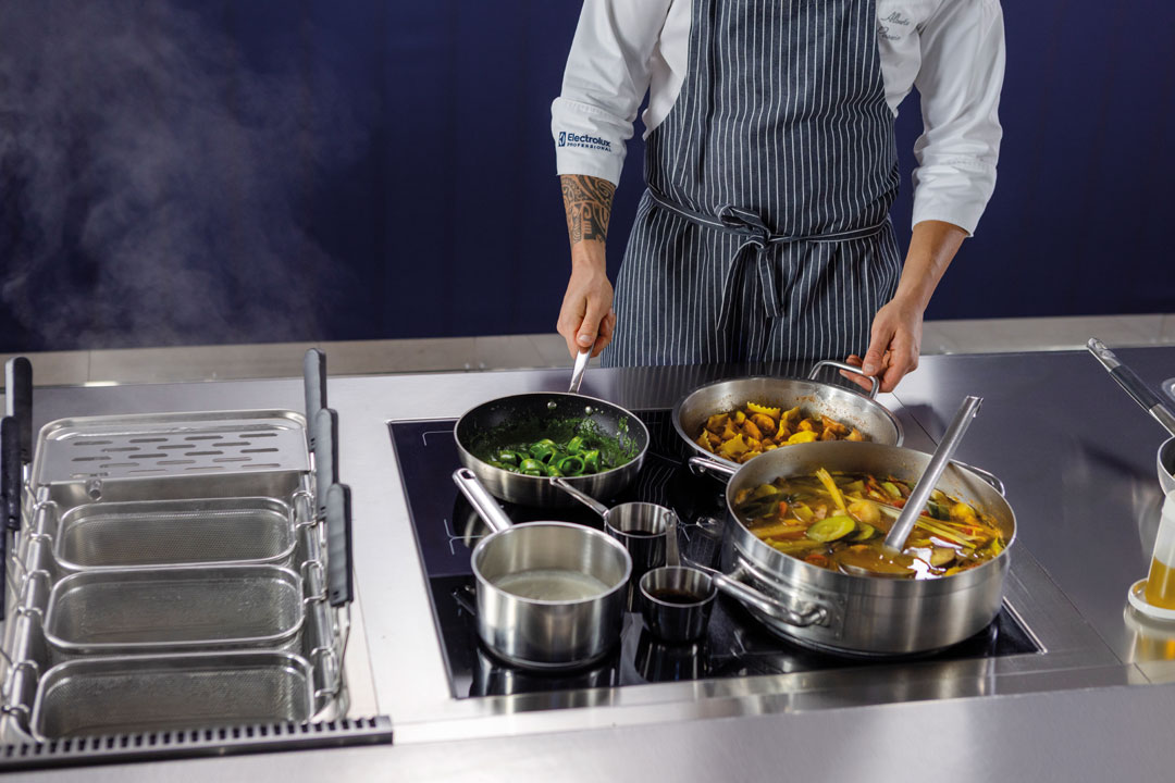 Modern commercial kitchen featuring induction cooking and efficient equipment