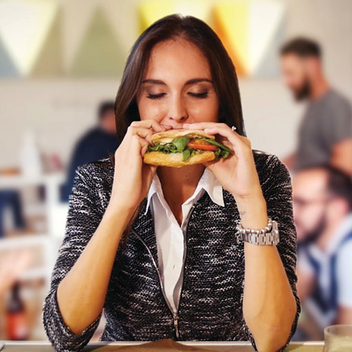 Girl eating freshly toasted sandwich from SpeeDelight